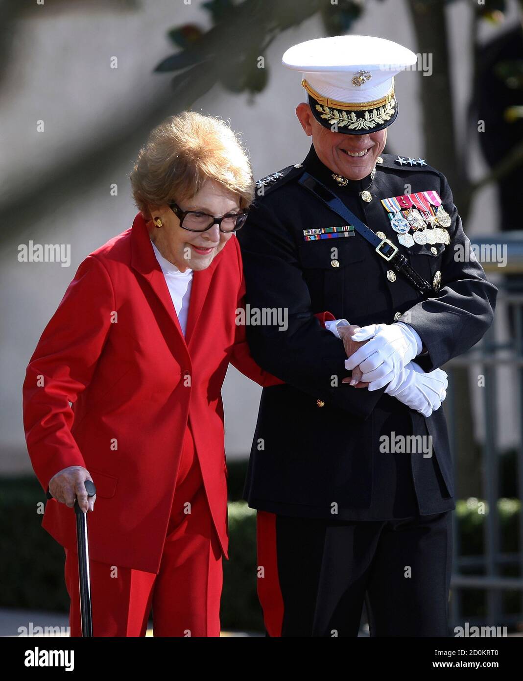 U.S. Marine Corps Lieutenant General George Flynn (R) escorts former U.S First Lady Nancy Reagan to the laying of the wreath ceremony at the resting place of her husband former U.S. President Ronald Reagan, during his posthumous 100th birthday celebration at the President Reagan Memorial Site at Reagan Library in Simi Valley February 6, 2011. REUTERS/David McNew/Pool (UNITED STATES - Tags: POLITICS MILITARY ANNIVERSARY OBITUARY IMAGES OF THE DAY) Stock Photo