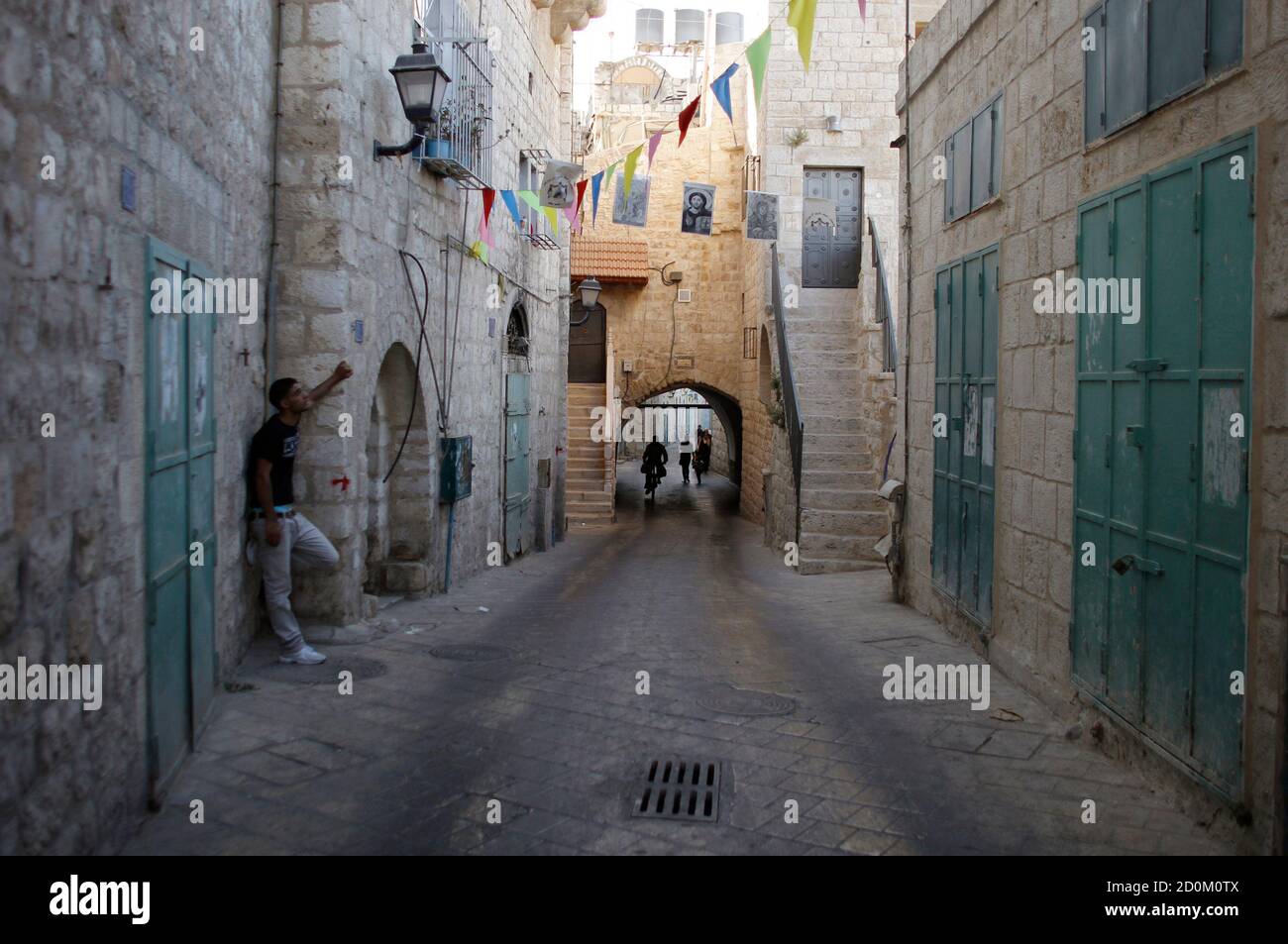 A Palestinian stands on a section of the Pilgrimage Route, the path which tradition says Joseph and Mary took into the West Bank city of Bethlehem in their trek from Nazareth some 2,000 years ago, June 28, 2012. Palestinians hope to persuade UNESCO this weekend to declare parts of Bethlehem, including the Pilgrimage Route, and its Church of the Nativity endangered World Heritage sites in order to expedite funding for repairs. REUTERS/Ammar Awad (WEST BANK - Tags: POLITICS RELIGION) Stock Photo