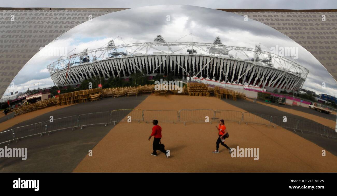 The Olympic Stadium is reflected by a large polished convex steel mirror at a corporate sponsor's pavilion in the Olympic Park, Stratford, east London, July 19, 2012. The 2012 London Olympic Games will begin in just over a week.  REUTERS/Andrew Winning (BRITAIN - Tags: SPORT OLYMPICS) Stock Photo