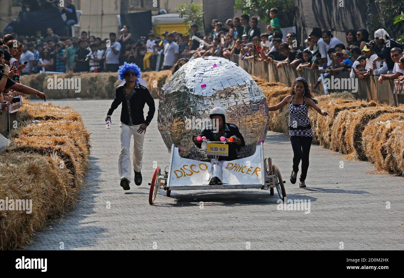 A contestant rides a home-made disco ball shaped vehicle without an engine  down a hill during the Red Bull Soapbox Race in Mumbai December 2, 2012.  The race is judged on speed,