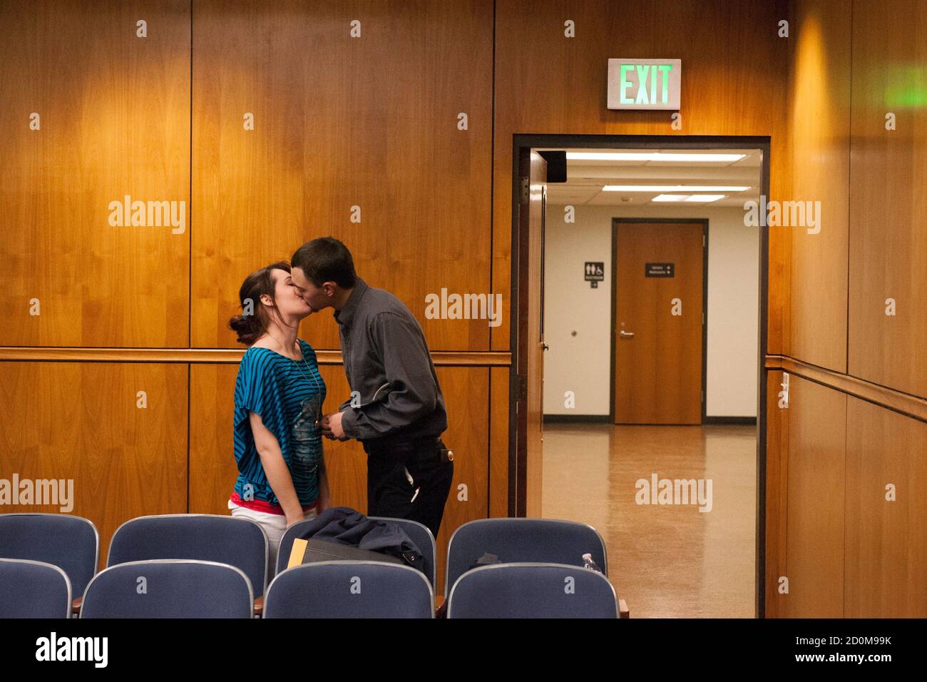 Terra Green (R) and Jeff Williamson (L) kiss after being married at the Williams County courthouse in Williston, North Dakota February 6, 2015. Later the same day, Green took a bus back to Oregon, where she is from. Green and Williamson travelled to Williston with a friend, Bazileo Hernandez, in search of work. After trying unsuccessfully for over a month to find work, the friends decided to leave Williston.   REUTERS/Andrew Cullen   (UNITED STATES - Tags: BUSINESS COMMODITIES EMPLOYMENT SOCIETY)  PICTURE 22 OF 28 FOR WIDER IMAGE STORY 'IN PURSUIT OF THE AMERICAN DREAM'  SEARCH 'CULLEN DREAM'  Stock Photo