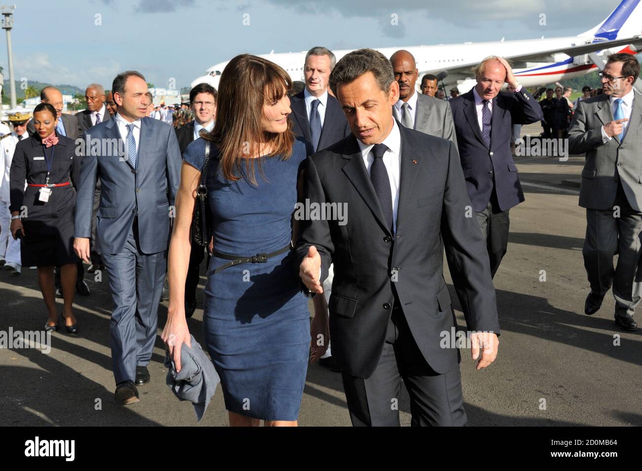 France's President Nicolas Sarkozy and First Lady Carla Bruni-Sarkozy  arrive at Fort-de-France airport on Martinique island January 7, 2011.  Sarkozy and his wife travel to Martinique and Guadeloupe to deliver the New