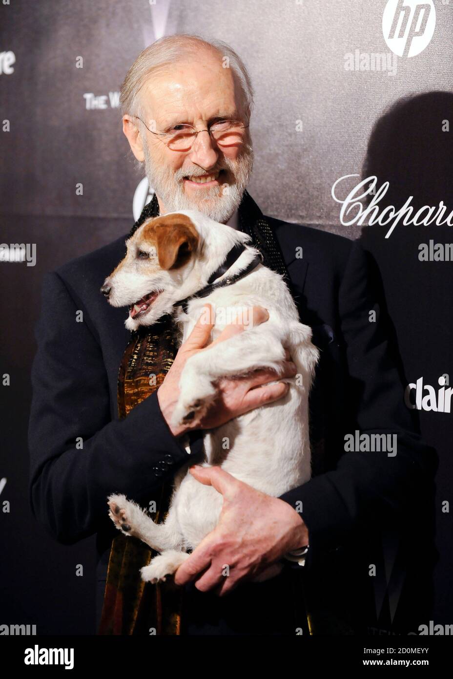 Actor James Cromwell holds Uggie, a Jack Russell terrier from "The Artist,"  during their arrival at the The Weinstein Company after party following the  69th annual Golden Globe Awards in Beverly Hills,