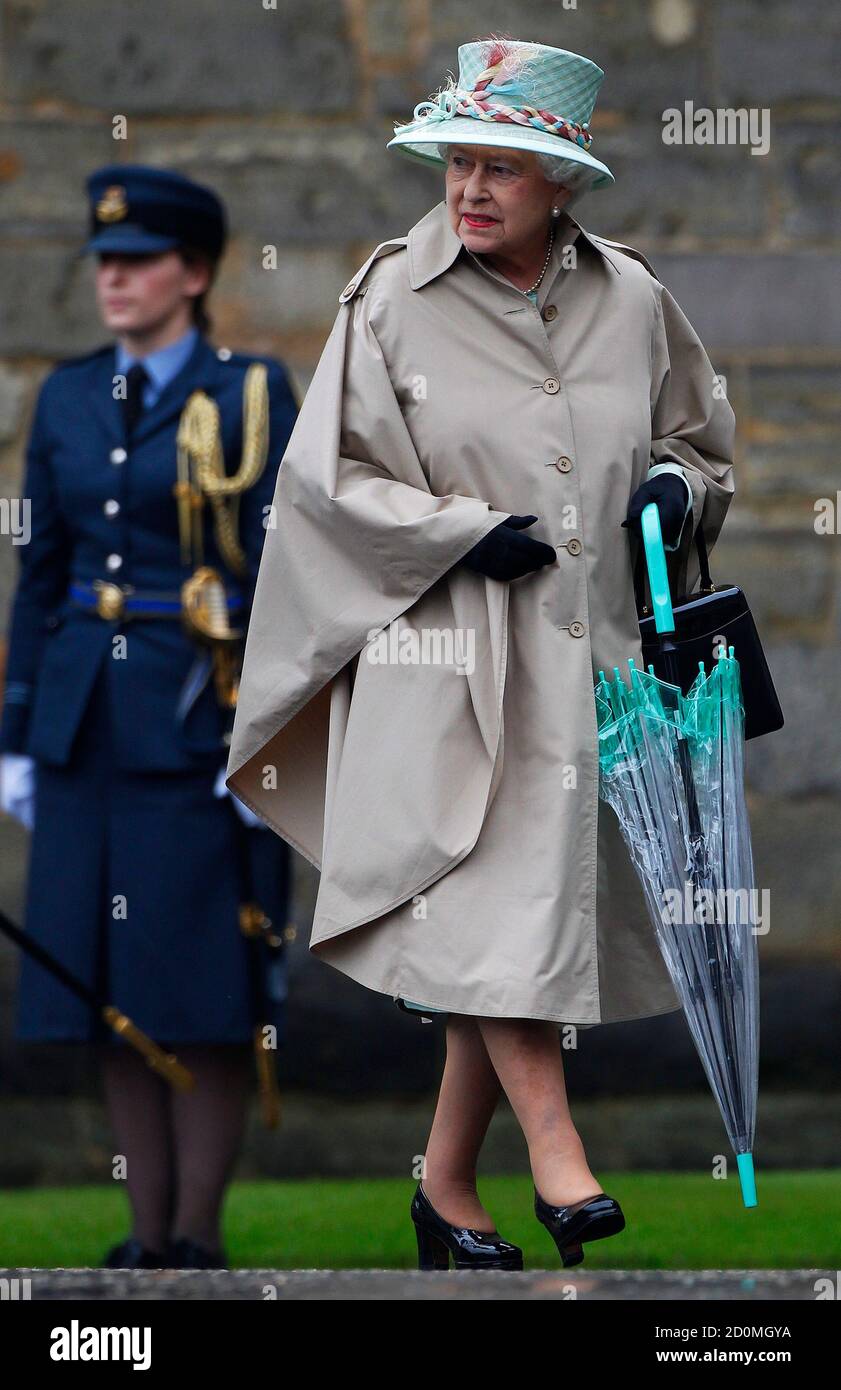 Britain's Queen Elizabeth walks carrying an umbrella as she as she attends  the Ceremony Of The Keys at Holyrood Palace in Edinburgh, Scotland July 2,  2012. The ceremony marks the start of