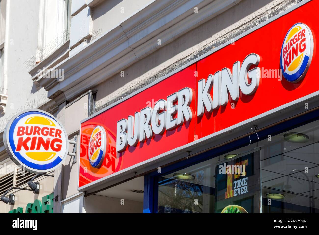 London, UK, April 1, 2012 : Burger King yellow and red logo advertising sign outside a beefburger fast food retail business restaurant in the city cen Stock Photo