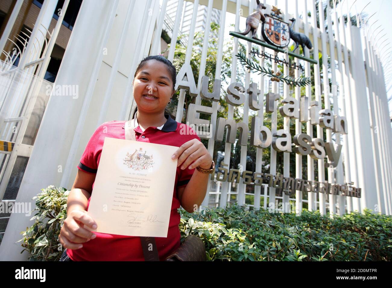 Thai surrogate mother Pattaramon shows a certificate of Australian citizenship for the baby she gave birth to, to the media at the Australian Embassy, in Bangkok 9, 2015. Baby Gammy,