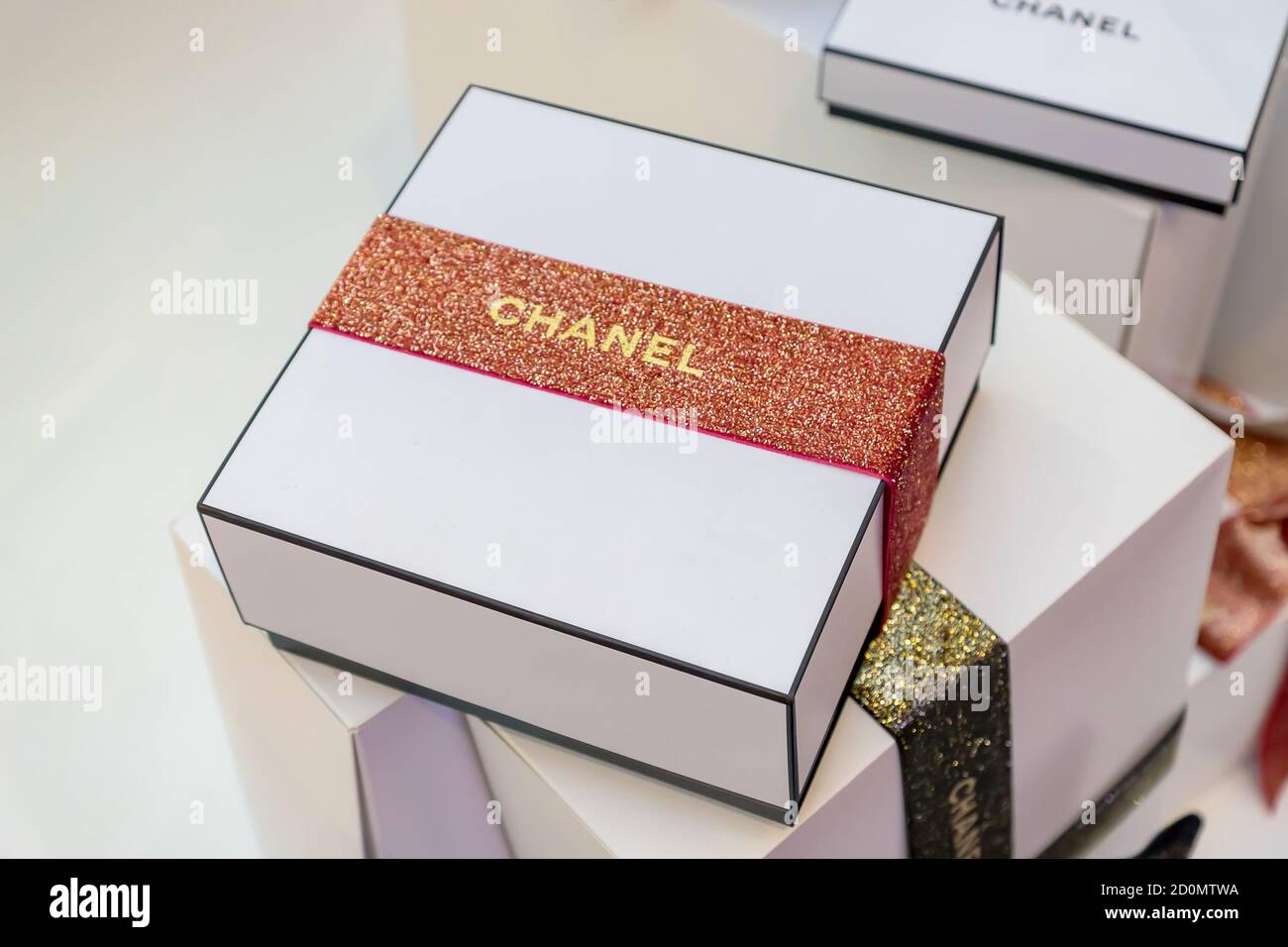 Chanel Gold and Black Christmas Gift Boxes with ribbons. New Year's festive  packaging Stock Photo - Alamy