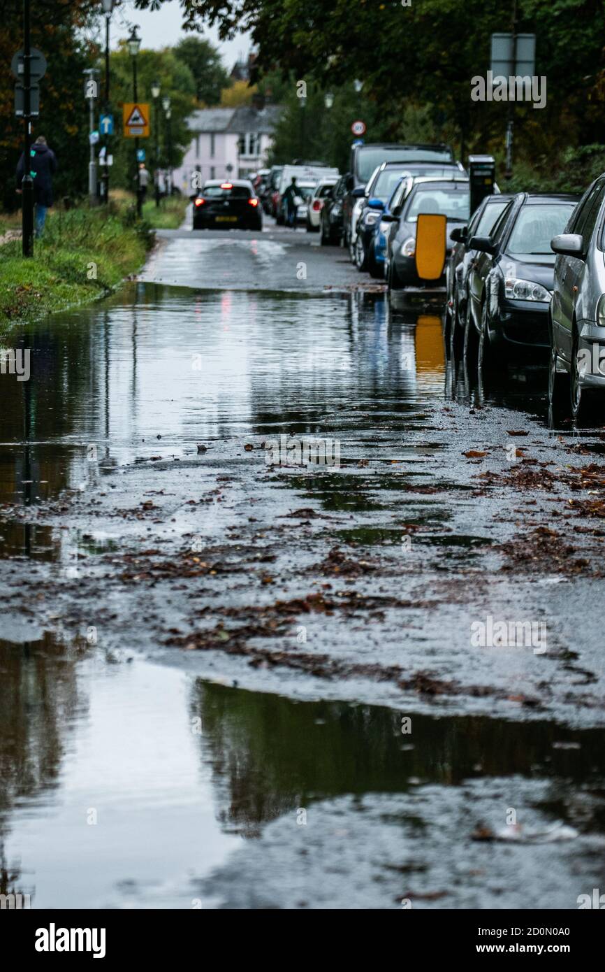 WIMBLEDON LONDON,UK 3 October 2020. Cars parked on a flooded  road in Wimbledon Common following heavy overnight rain brought about by Storm Alex coming from France causing flooding and damage to many parts in Southern England.  Credit: amer ghazzal/Alamy Live News Stock Photo