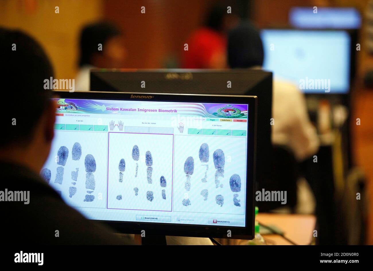 A monitor displays fingerprints of a foreign worker who just