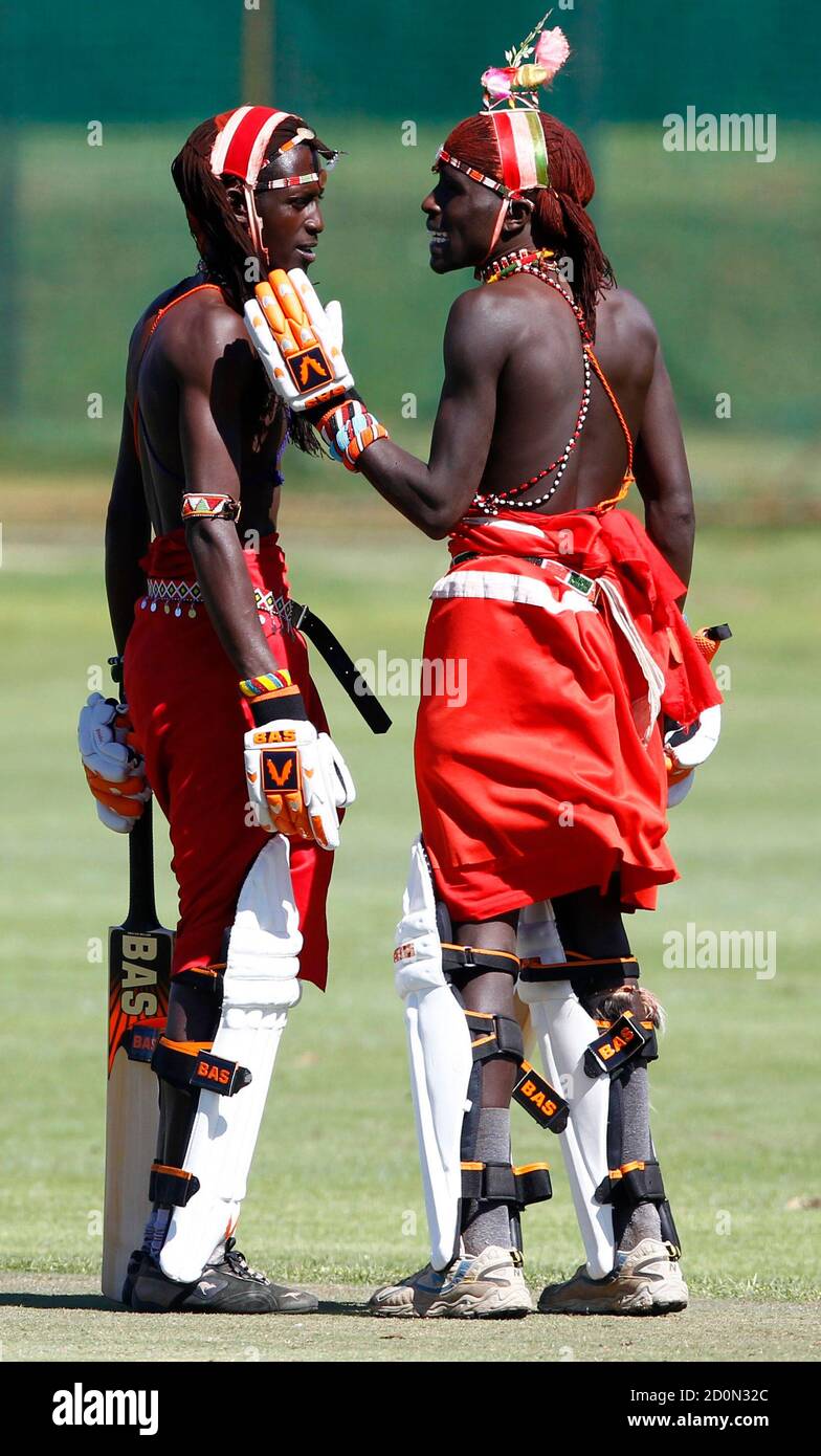 Kenya's Maasai Cricket Warriors players Tapele Ole Naimands (R) and Mulinge Ole Meshami talk during their 'Last Man Standing' Twenty20 (T20) cricket match against the Cricodillos in Cape Town March 31, 2012. The Maasai Cricket Warriors from Kenya are role models in their communities where they actively campaign against retrogressive and harmful cultural practices, such as female genital mutilation and early childhood marriages, while fighting to eradicate discrimination against women in Maasailand. Through cricket, they hope to promote healthier lifestyles and to also spread awareness about HI Stock Photo