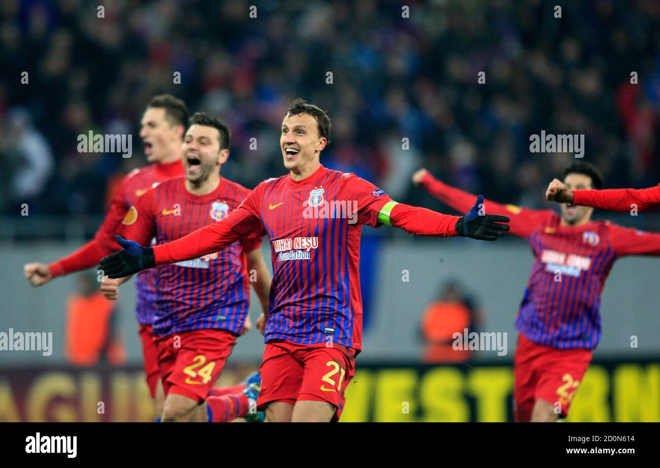 Vlad Chiriches (C) of Steaua Bucharest celebrates with his team mates after  winning their Europa League