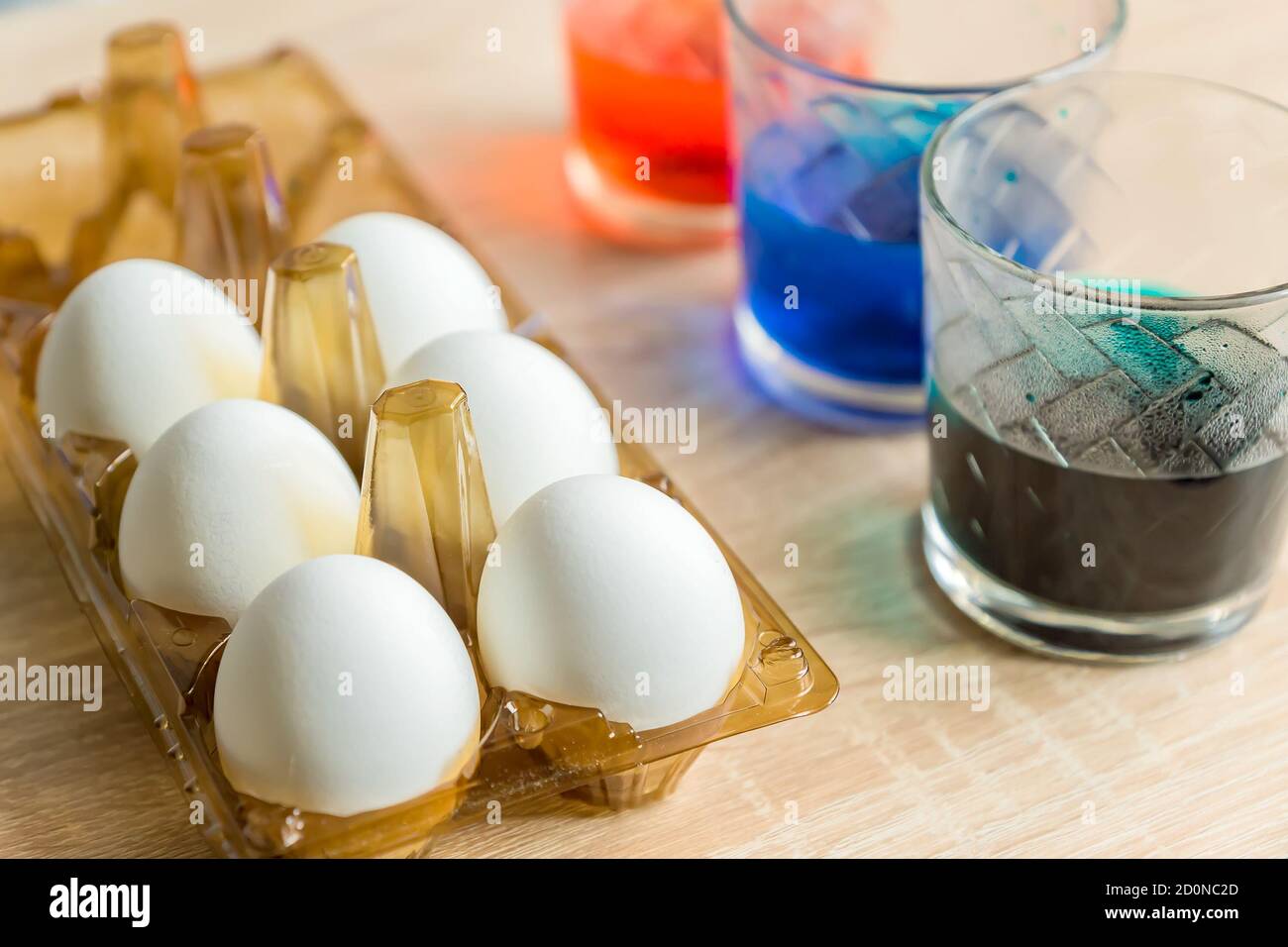 Easter Egg Dying Process. glasses with multicolored coloring water