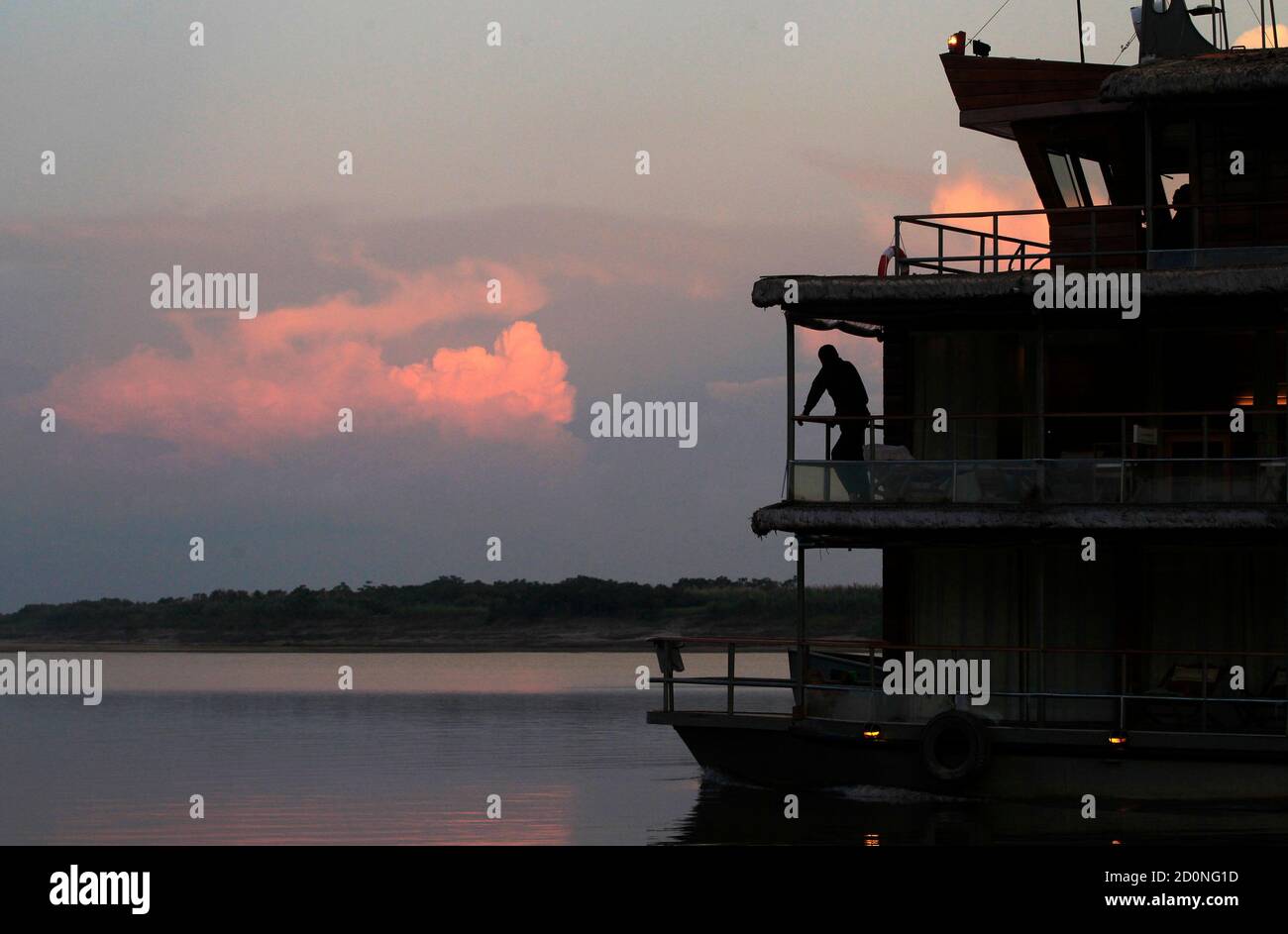 A man travels on a ship across the Maranon river, one of the two main  headwaters of the Amazon river, in Iquitos September 2, 2011. The  Geographic Society of Lima and Peru's