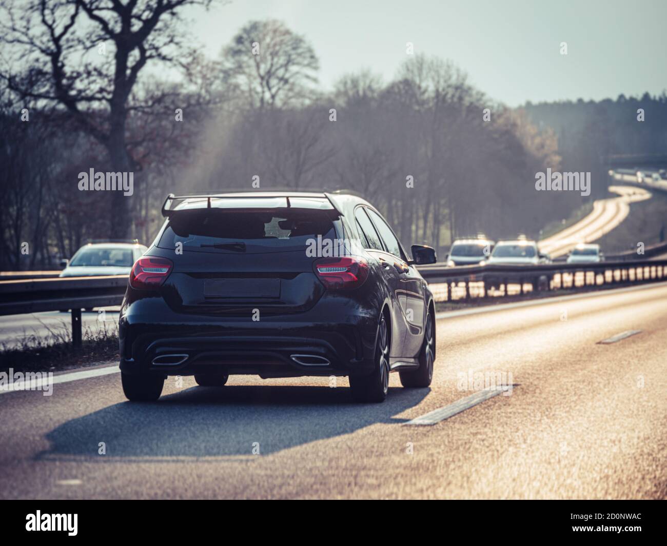 Blacksports car on German highway (Autobahn), selective focus blurry background Stock Photo