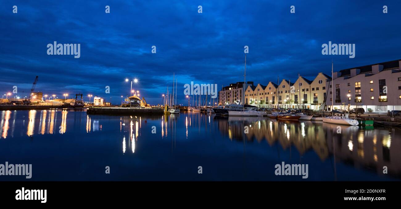Panorama of Galway city harbour docklands illuminated at night Stock Photo