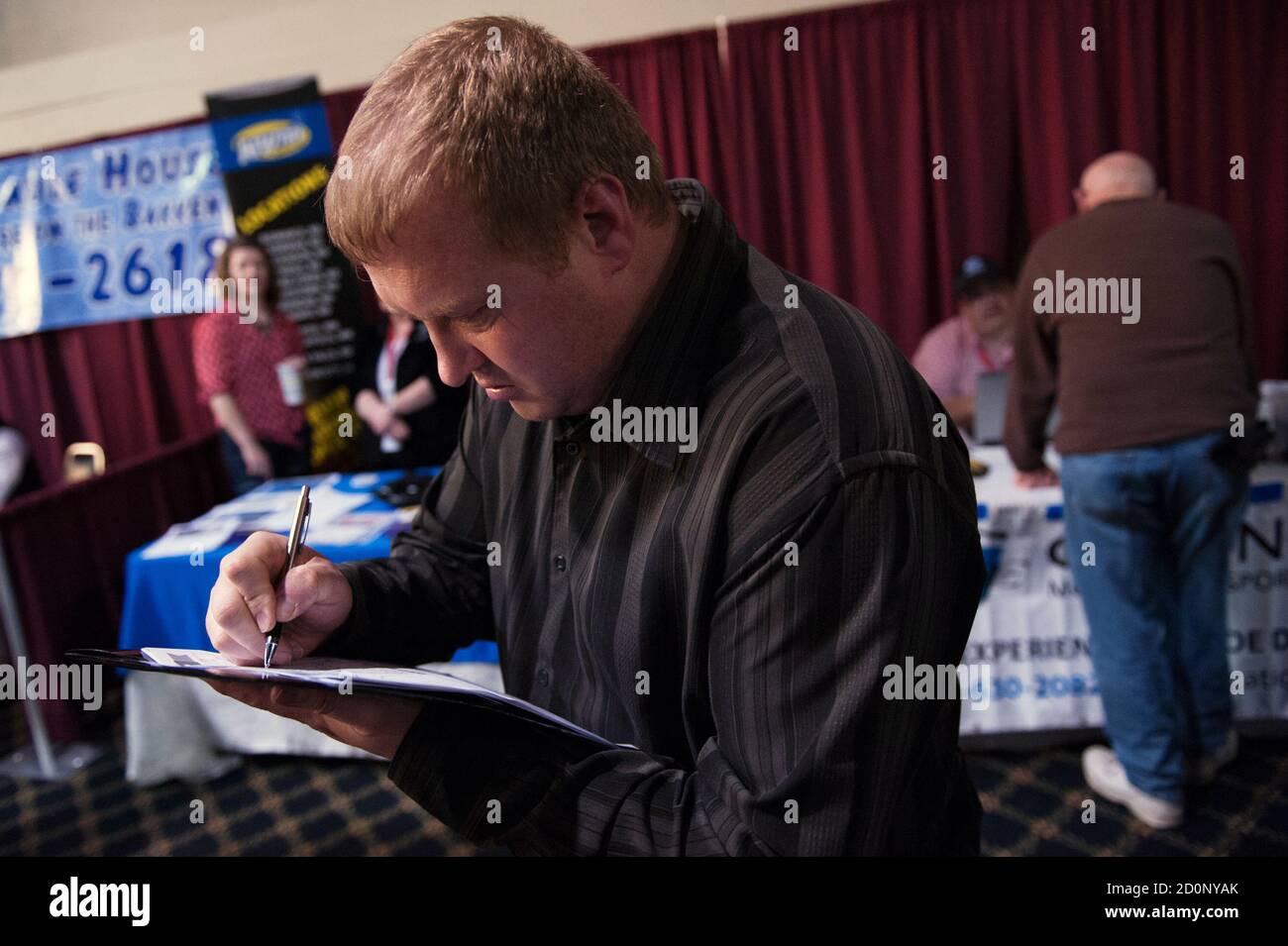 Ben Hinshaw, who came from Minnesota to attend a job fair in Williston, North Dakota March 11, 2015, fills out a form. REUTERS/Andrew Cullen    (UNITED STATES - Tags: BUSINESS EMPLOYMENT) Stock Photo