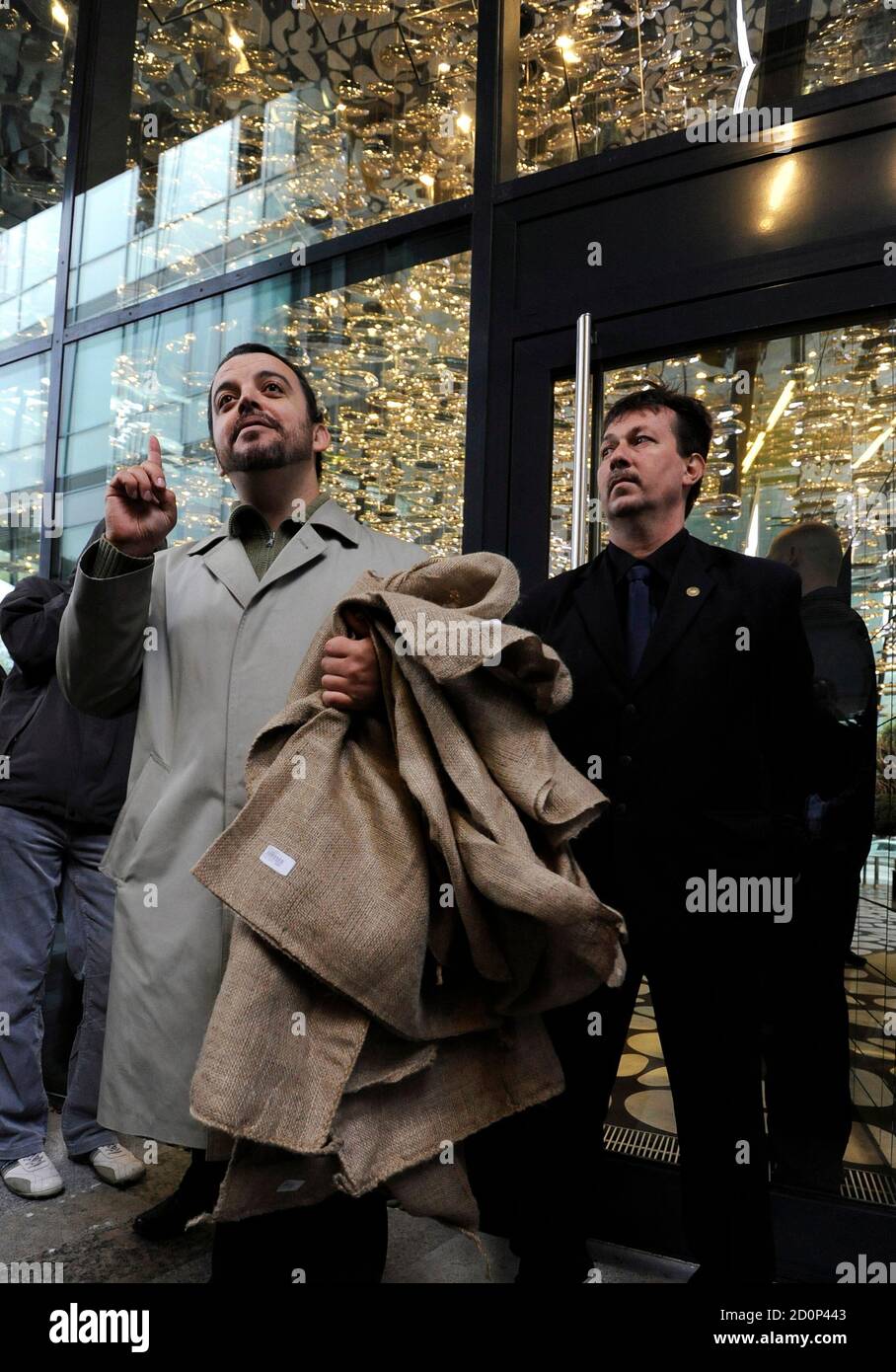 Civil activist Eduard Chmelar (L) holds sacks as he asks for money in front of the headquarters of the J&T financial group during a protest against oligarchy, corruption, and the greed of banks, developers and transnational corporations in Bratislava October 24, 2011. Members of the initiative for the Civil Constitution symbolically occupied the entrance to the building and asked for money for citizens.   REUTERS/Radovan Stoklasa (SLOVAKIA - Tags: BUSINESS CIVIL UNREST) Stock Photo