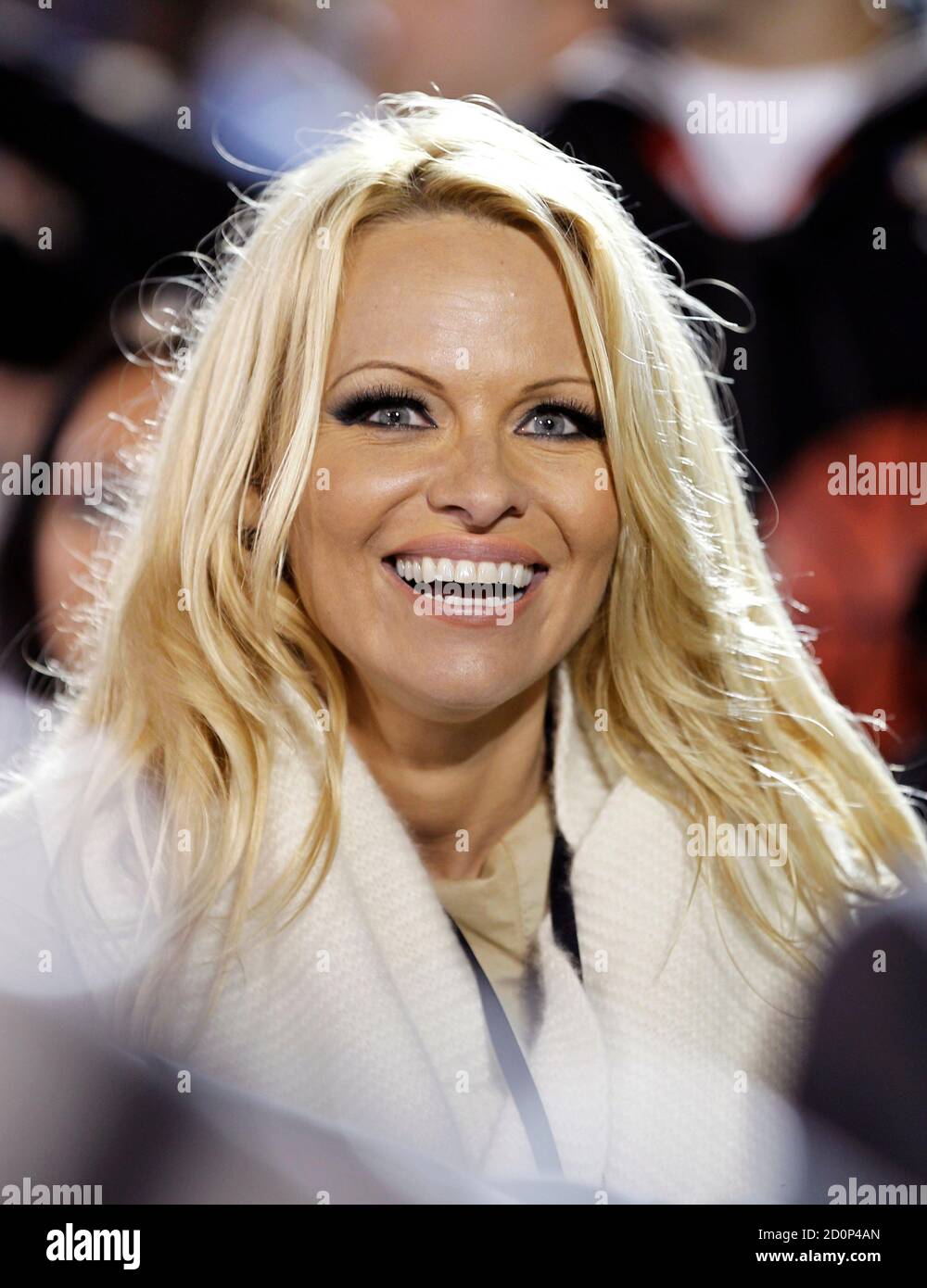 Actress Pamela Anderson watches the NCAA Carrier Classic men's college basketball game between Michigan State Spartans and the North Carolina Tar Heels on the deck of the aircraft carrier USS Carl Vinson in Coronado, California November 11, 2011.   REUTERS/Mike Blake     (UNITED STATES - Tags: SPORT BASKETBALL MILITARY ENTERTAINMENT HEADSHOT) Stock Photo