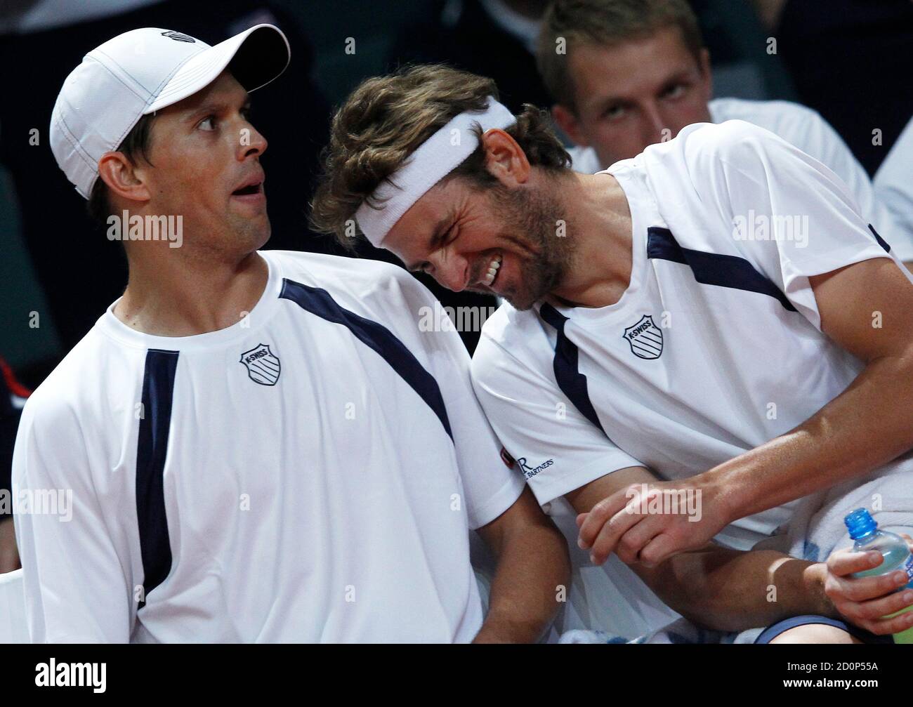 Mardy Fish (R) and Mike Bryan of the U.S. joke during the Davis Cup doubles  tennis match against Switzerland's Roger Federer and Stanislas Wawrinka in  Fribourg February 11, 2012. REUTERS/Michael Buholzer (SWITZERLAND -