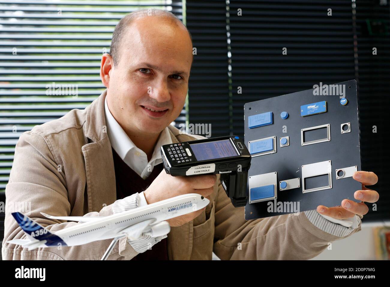Bruno Lo-Re, CEO of MAINtag, holds a selection of RFID radio-frequency  identification tags for aircraft as he poses for Reuters in his office in  Saint-Maur des Fosses near Paris October 16, 2012.