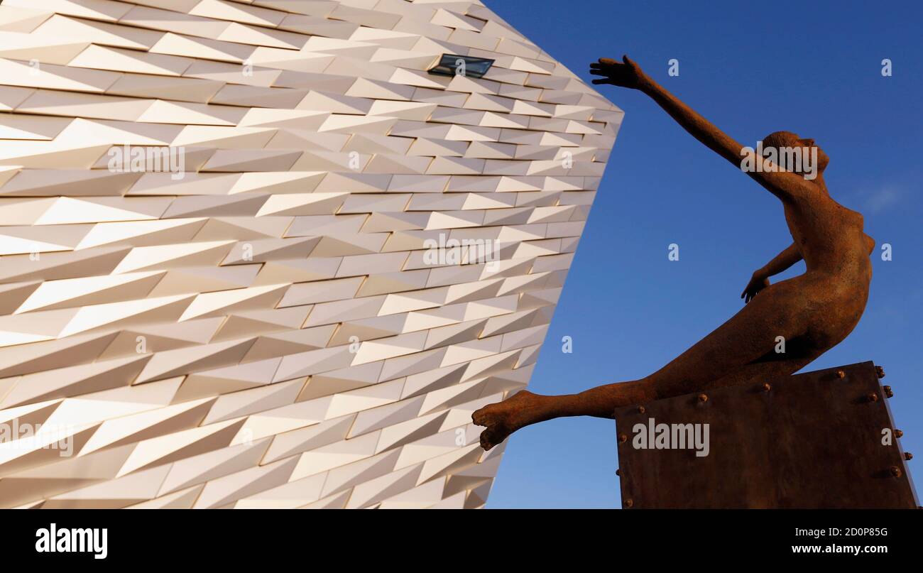 The 'Titanica' statue  is pictured in front of Titanic Belfast December 7, 2012. U.S. Secretary of State Hillary Clinton travelled to Northern Ireland on Friday to lend her support to the British province's fragile peace, the frailty of which was underlined by overnight rioting on the eve of her visit and the seizure of a bomb. Clinton visited the the recently opened building, which allows visitors to re-live the entire Titanic story from her birth in Belfast to the fateful maiden voyage.   REUTERS/Kevin Lamarque (NORTHERN IRELAND - Tags: POLITICS MARITIME) Stock Photo