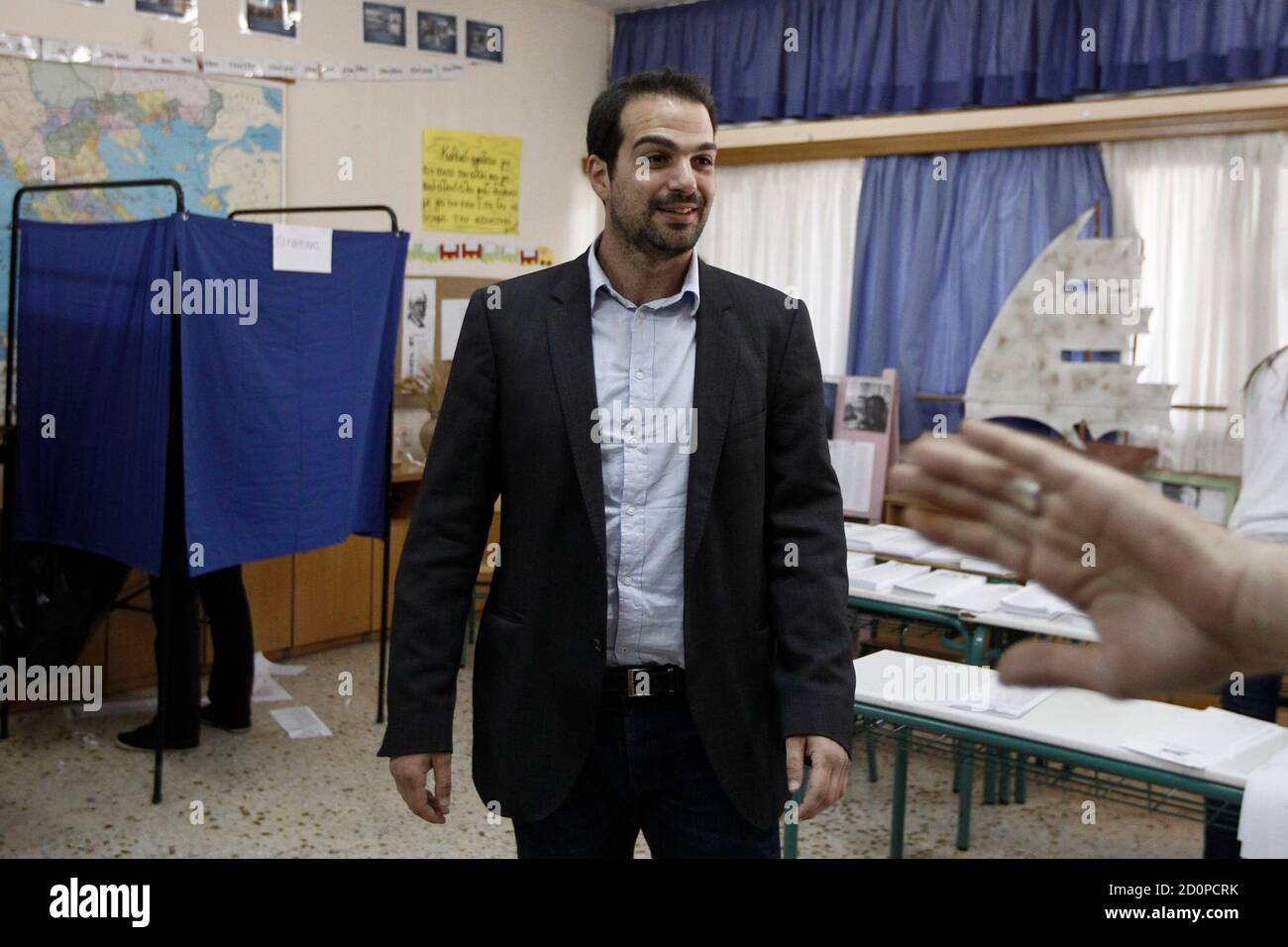 Mayoral candidate for the city of Athens Gabriel Sakellaridis arrives to  visit a school used as a polling station in Athens, May 25, 2014. Greeks  voted in European and local elections on
