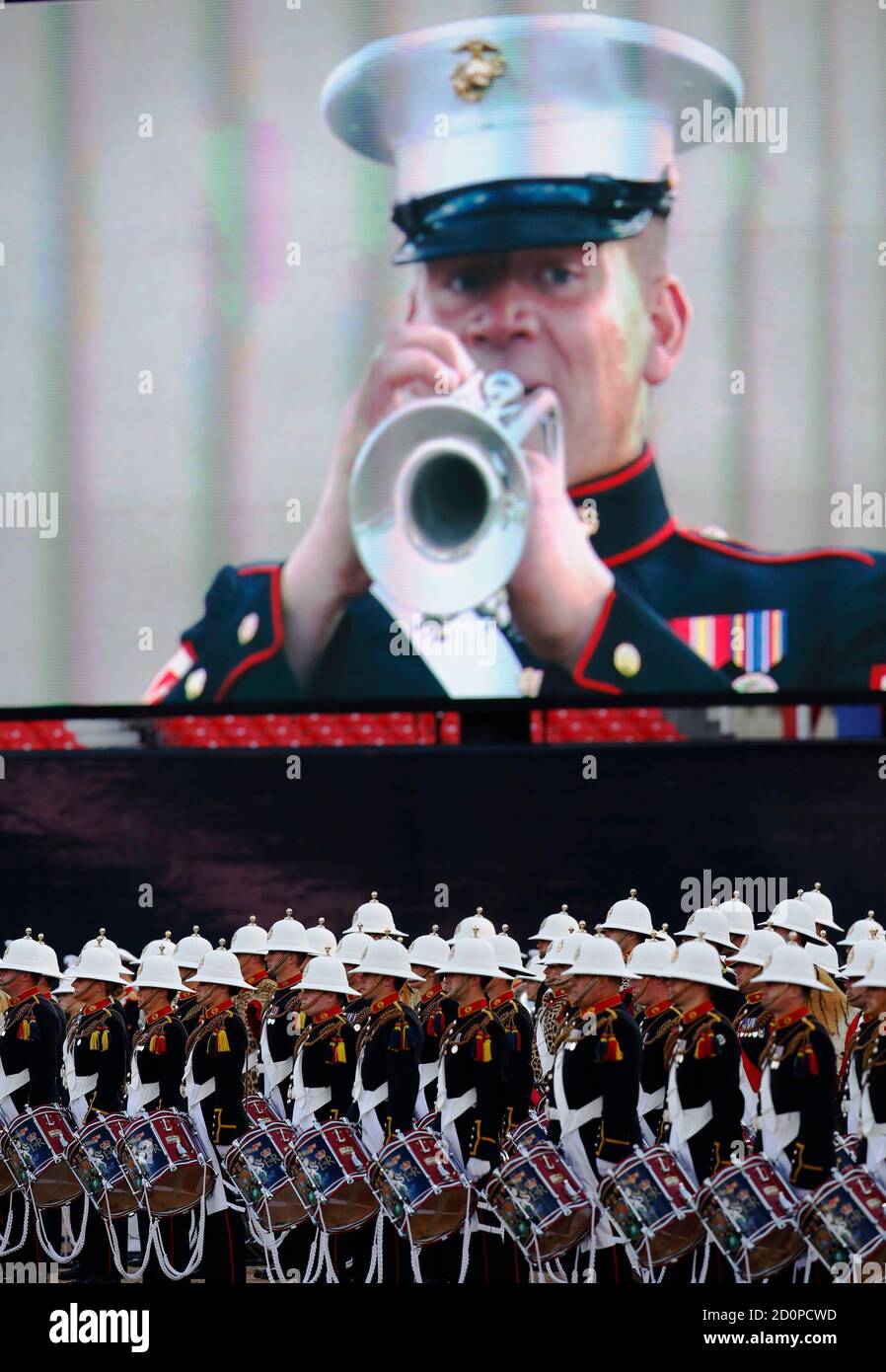 Musicians of the Royal Marines (bottom) perform alongside soldiers from the 2nd Marine Division Band, United States Marine Corps (top) in the largest 'Beating Retreat' military pageant in front of Britain's Prince Philip, which is also attended by Queen Elizabeth, at the Horse Guards Parade in London June 4, 2014. A total of 490 military personnel and musicians performed in the annual 'Beating Retreat' this year to celebrate the 350th anniversary of the Royal Marines. REUTERS/Luke MacGregor (BRITAIN - Tags: MILITARY ROYALS ANNIVERSARY POLITICS) Stock Photo