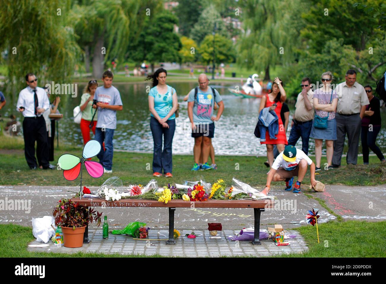People gather in memory of actor Robin Williams at a bench that was the  site of a scene in the movie 