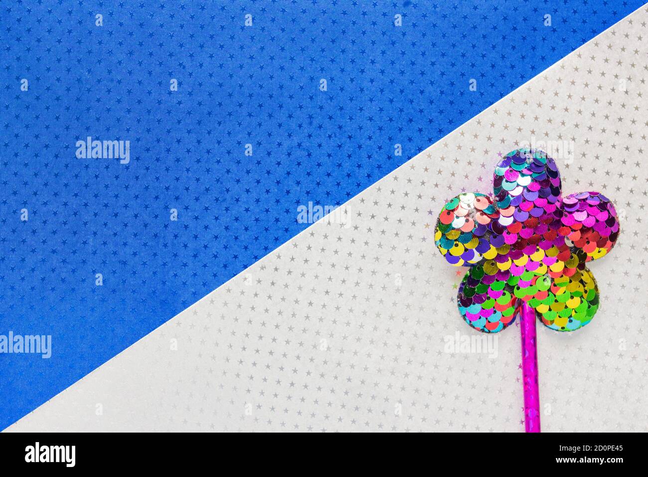 flower made of sequins on double white and blue star background background. Minimal flat lay, copy space Stock Photo