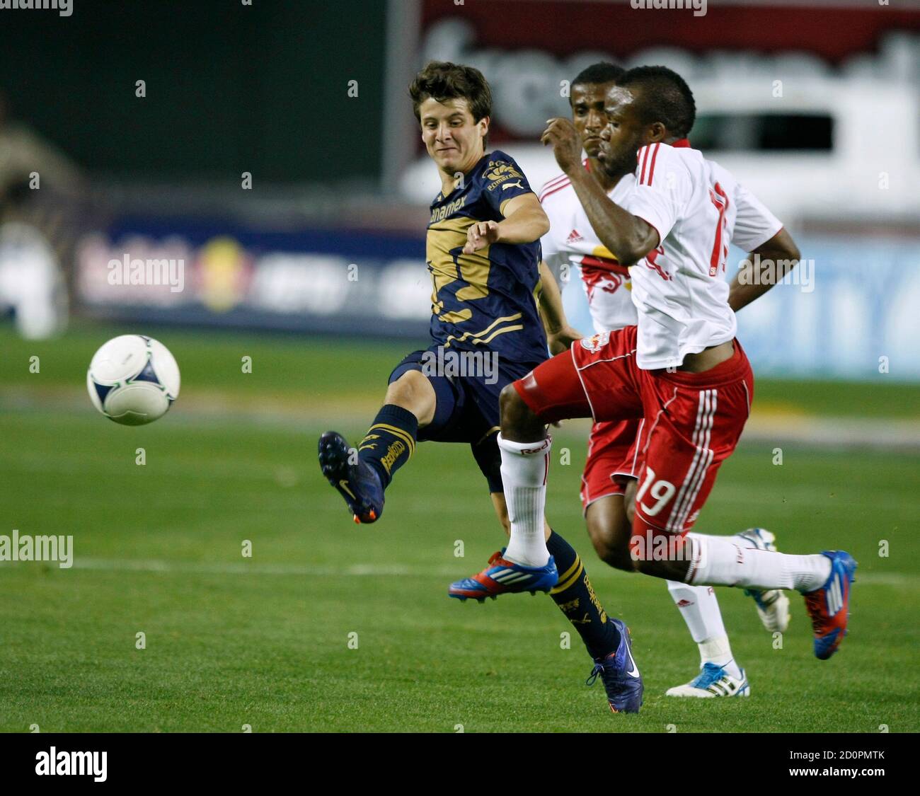 Pumas UMAN's Erik Vera (L) clears the ball against New York Red Bulls  forward Dane Richards in the second half of their friendly soccer match in  Phoenix, Arizona, February 23, 2012. REUTERS/Rick