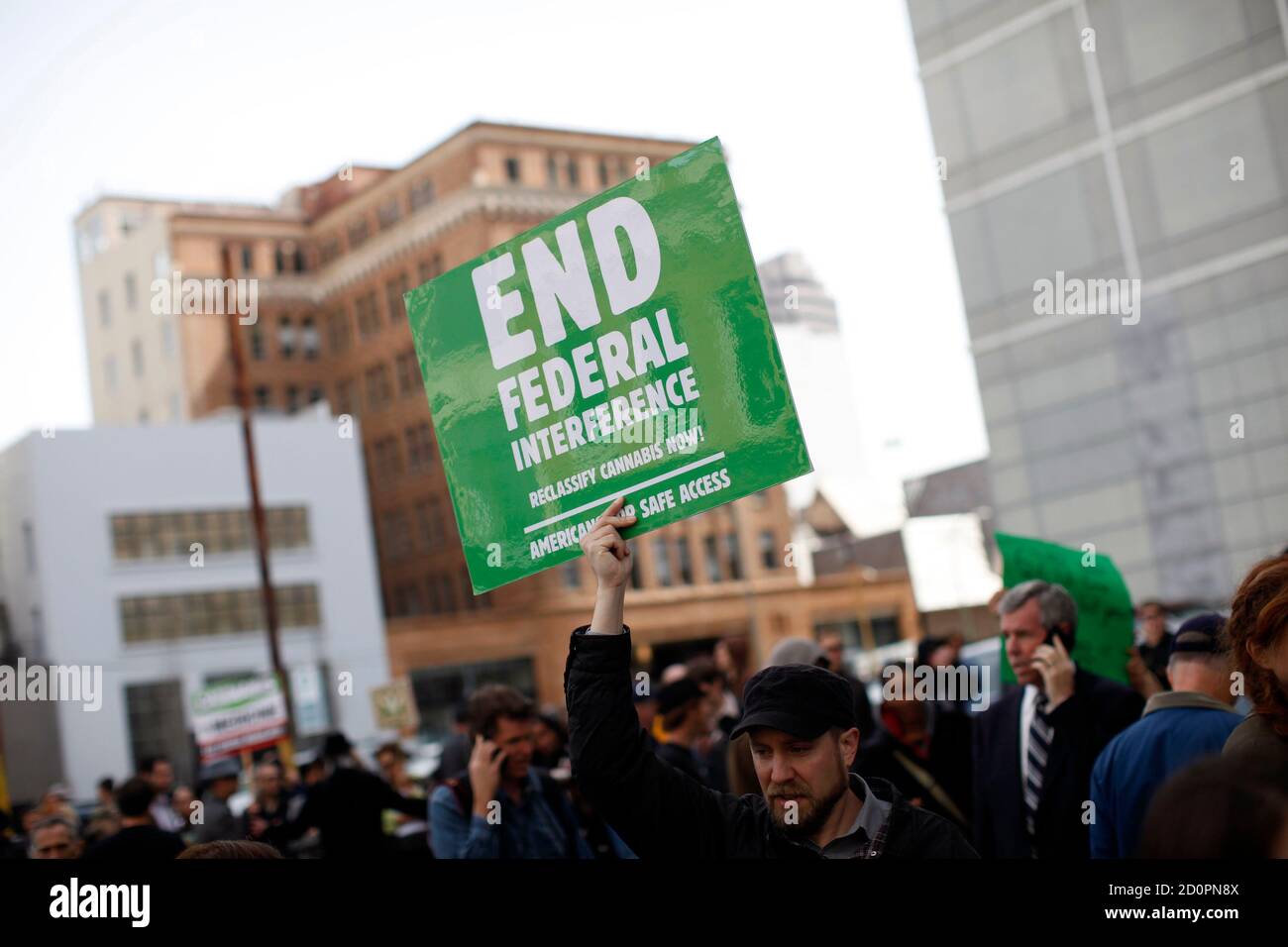 Roger LaChance of Oakland holds a sign in protest as federal agents conduct a raid on Oaksterdam University, a cannabis cultivation college, in Oakland, California April 2, 2012. Federal agents raided a cannabis cultivation college on Monday in the San Francisco Bay area widely known as the 'Princeton of Pot' and the 'Harvard of Hemp,' authorities said, as the U.S. government pressed its clamp-down on medical marijuana.  REUTERS/Stephen Lam (UNITED STATES - Tags: CRIME LAW DRUGS SOCIETY CIVIL UNREST) Stock Photo