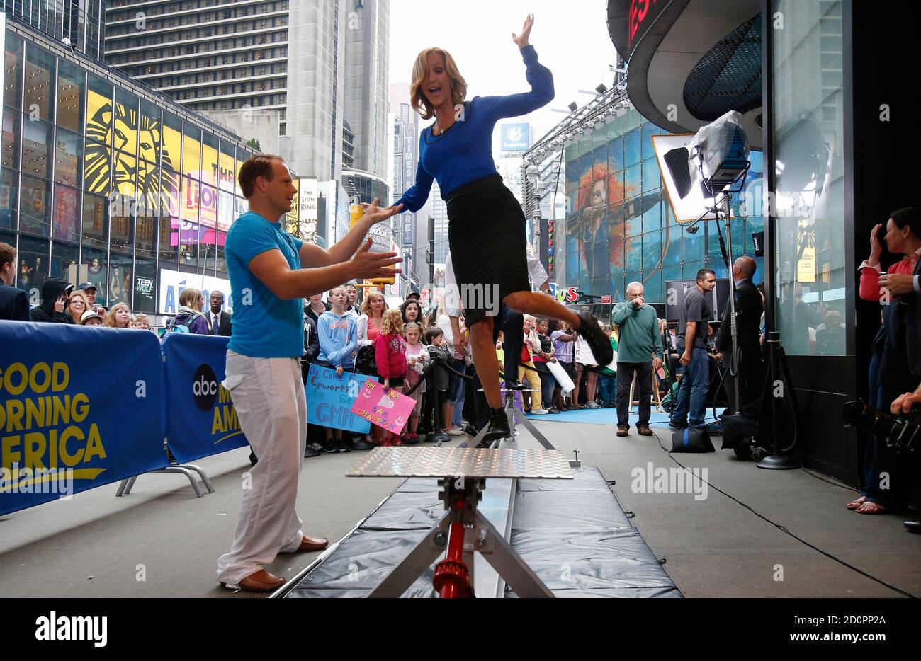 Daredevil Nick Wallenda (L) helps ABC's Lara Spencer walk on a tightrope  wire outside the set of ABC's Good Morning America program in New York City  June 13, 2012. Wallenda, 33, a