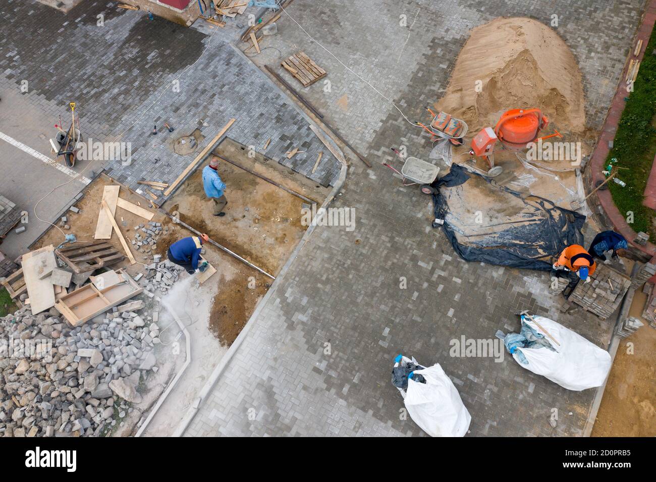workers lay paving slabs top view. Stock Photo