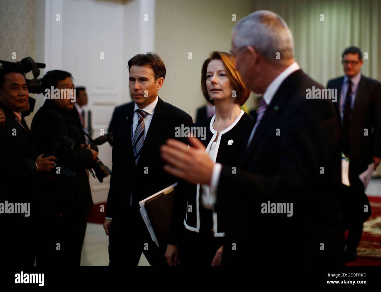 Australian Prime Minister Julia Gillard (C) walks between bilateral  meetings at the East Asia Summit in Phnom Penh, November 20, 2012.  REUTERS/Jason Reed (CAMBODIA - Tags: POLITICS Stock Photo - Alamy