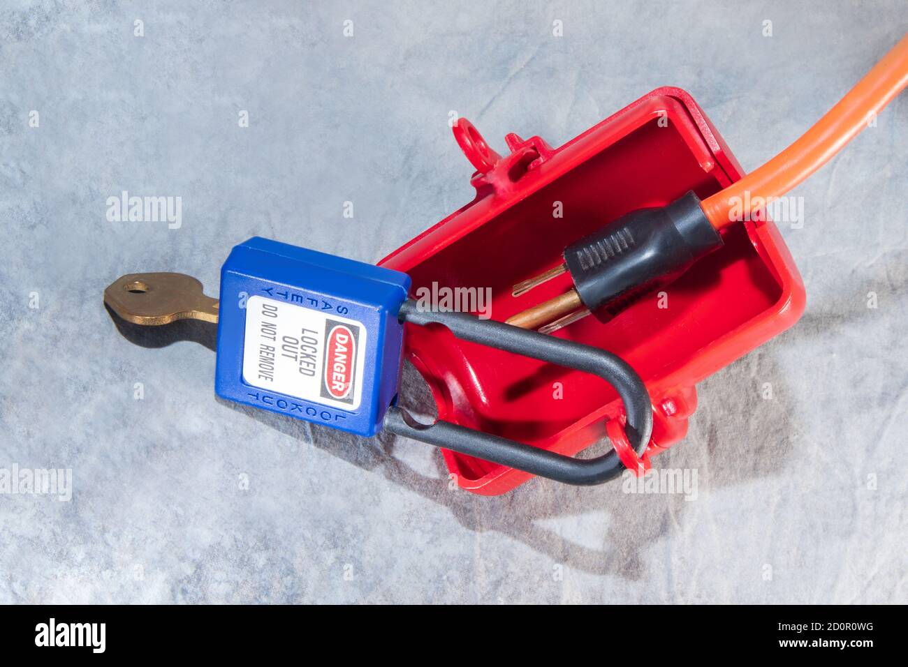 electrical plug lockout device secured with padlock and key for locking out electrical plugs