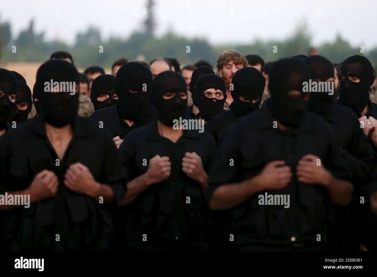 Rebel fighters take part in a military display as part of a graduation ceremony at a camp in eastern al-Ghouta, near Damascus, Syria July 12, 2015. The newly graduated rebel fighters, who went through military training, will join the the Free Syrian Army's Al Rahman legion. REUTERS/Bassam Khabieh      TPX IMAGES OF THE DAY Stock Photo