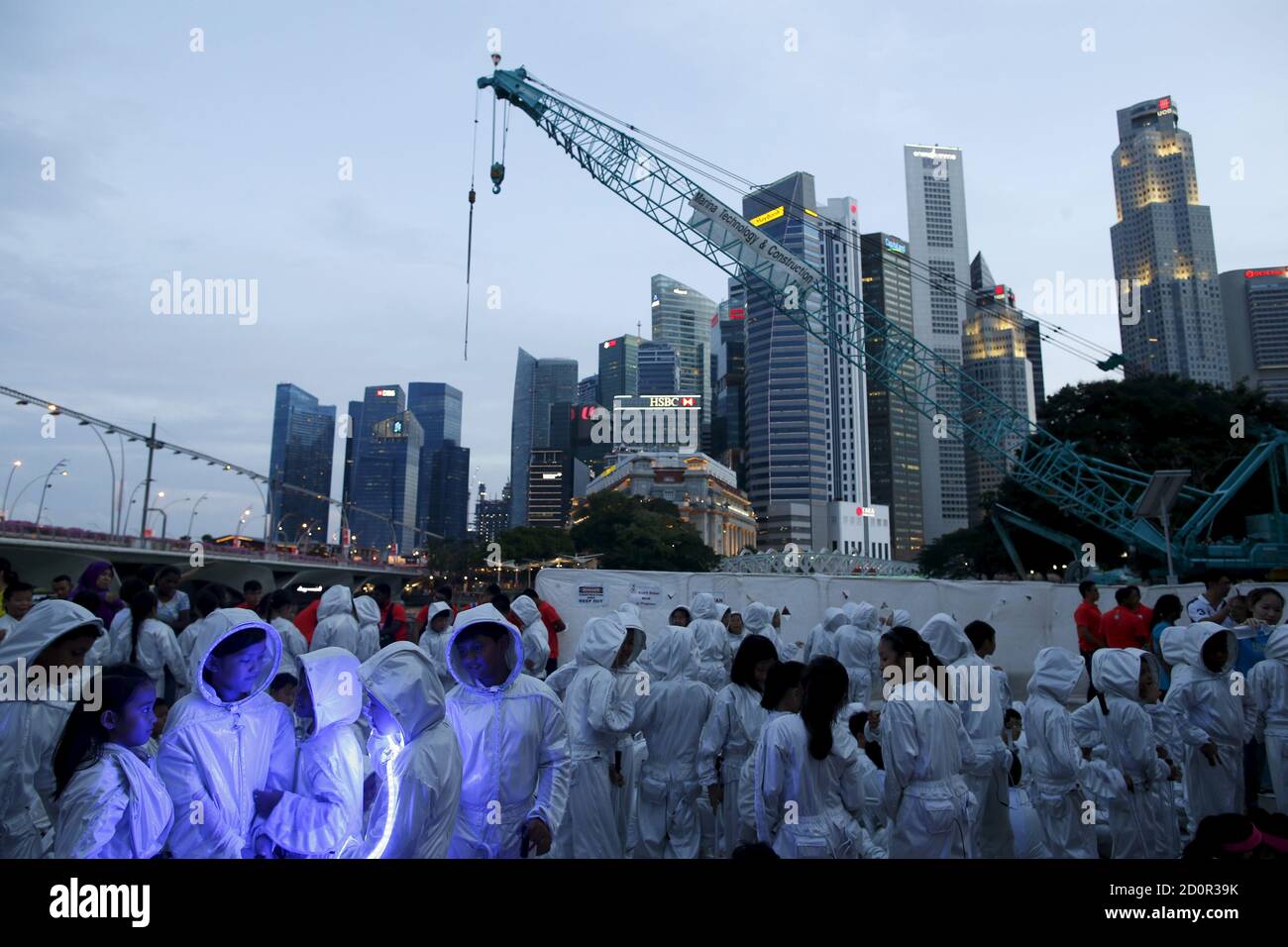 Children wearing costumes that light up with LED lights prepare to march into a National Day Golden Jubilee parade rehearsal at the Padang in Singapore July 25, 2015. The city-state's 50th independence day falls on August 9. REUTERS/Edgar Su Stock Photo