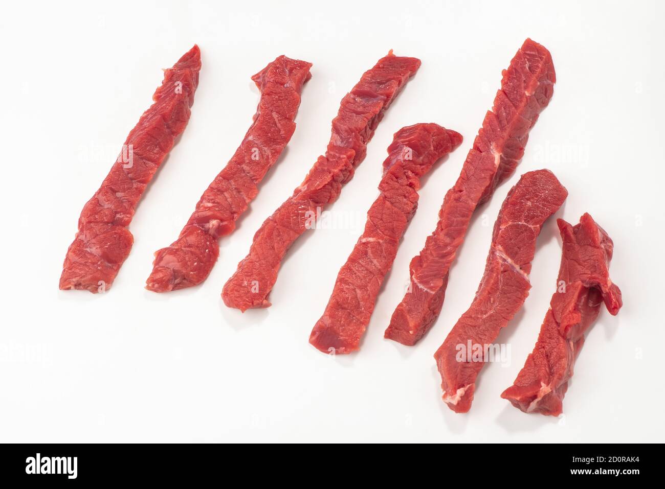 Beef steak cut into strips on white background Stock Photo Alamy