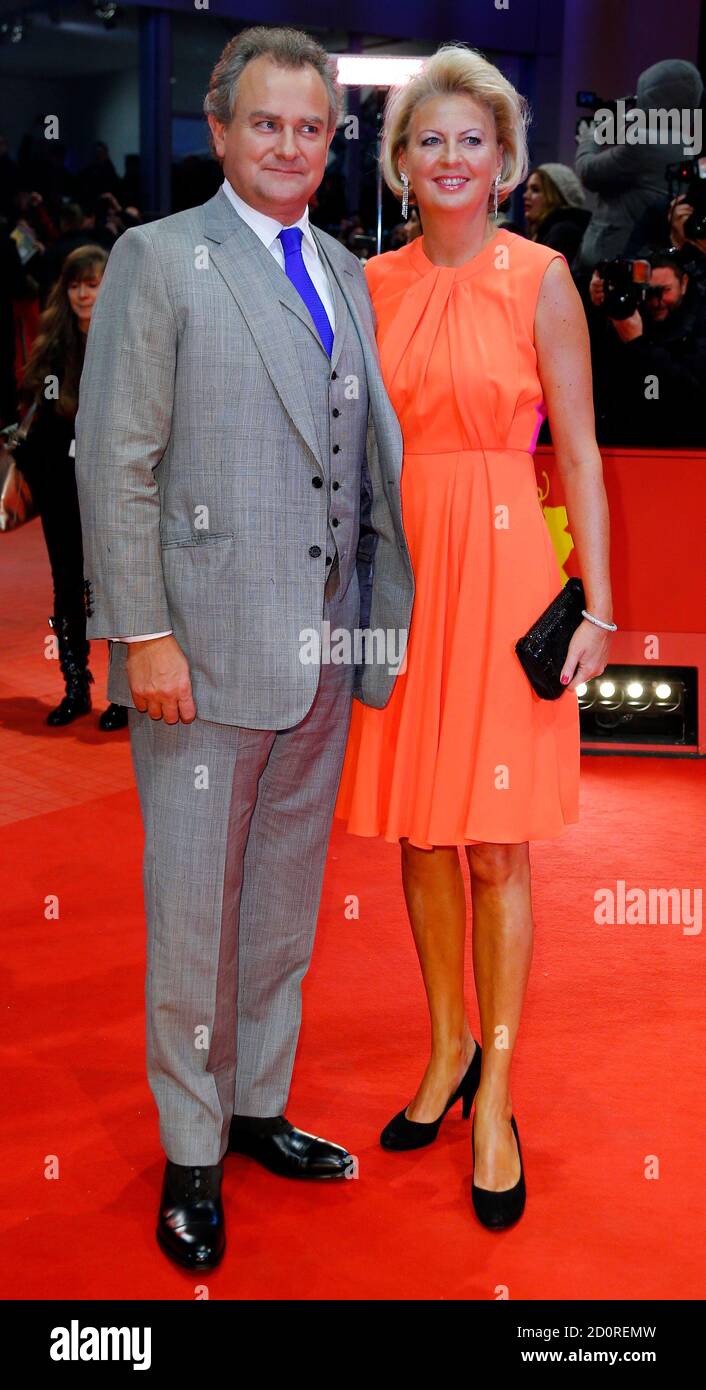 Cast member Hugh Bonneville and his wife Lulu Evans (R) arrive on the red  carpet for a screening of the movie 'The Monuments Men' at the 64th  Berlinale International Film Festival in