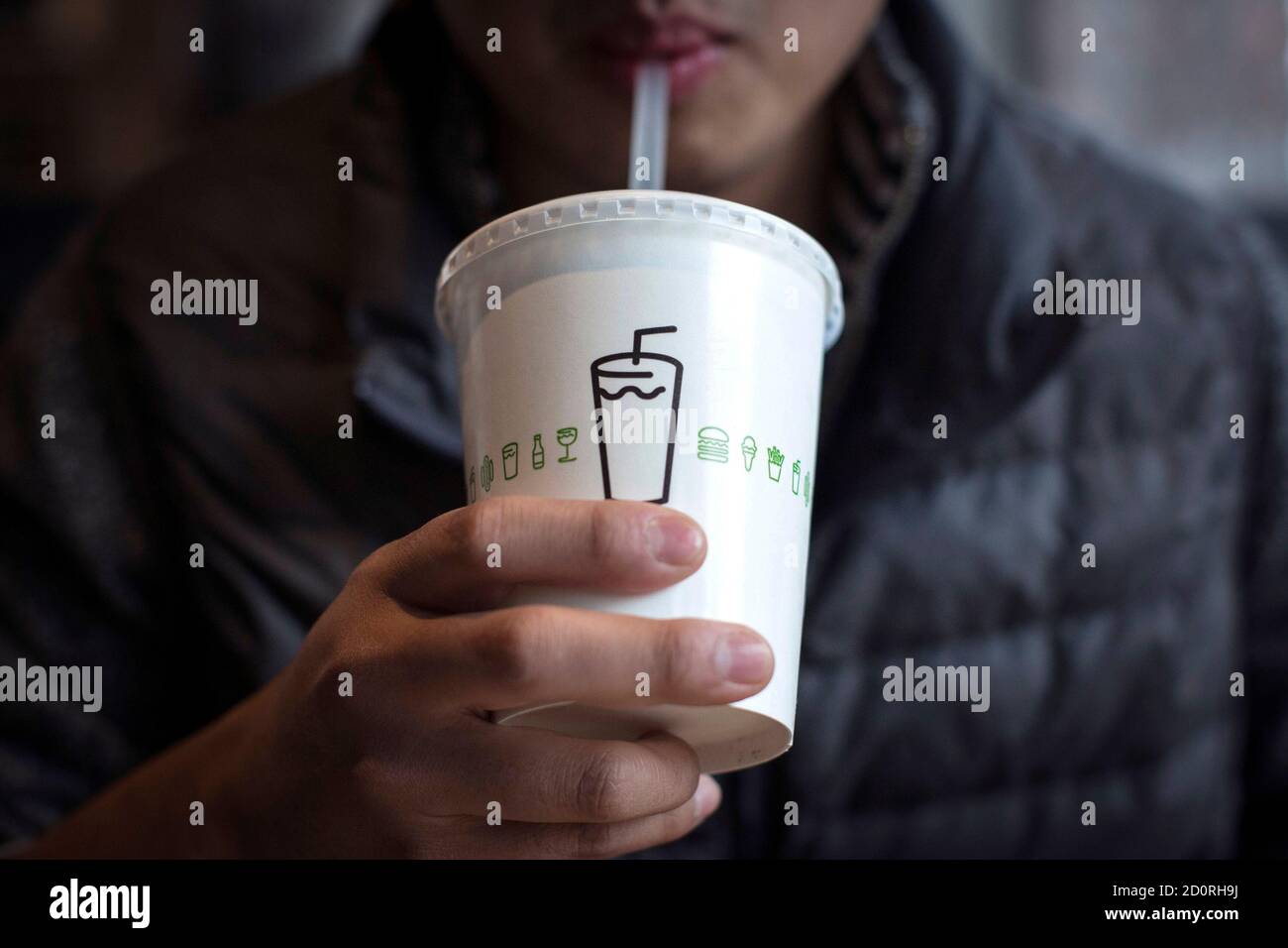 A man drinks a shake at Shake Shack in New York January 30, 2015. Shares of trendy hamburger chain Shake Shack Inc soared as much as 150 percent in their first day of trading on Friday, valuing the company that grew out of a hotdog cart in New York's Madison Square Park at nearly $2 billion. REUTERS/Andrew Kelly (UNITED STATES - Tags: BUSINESS FOOD) Stock Photo