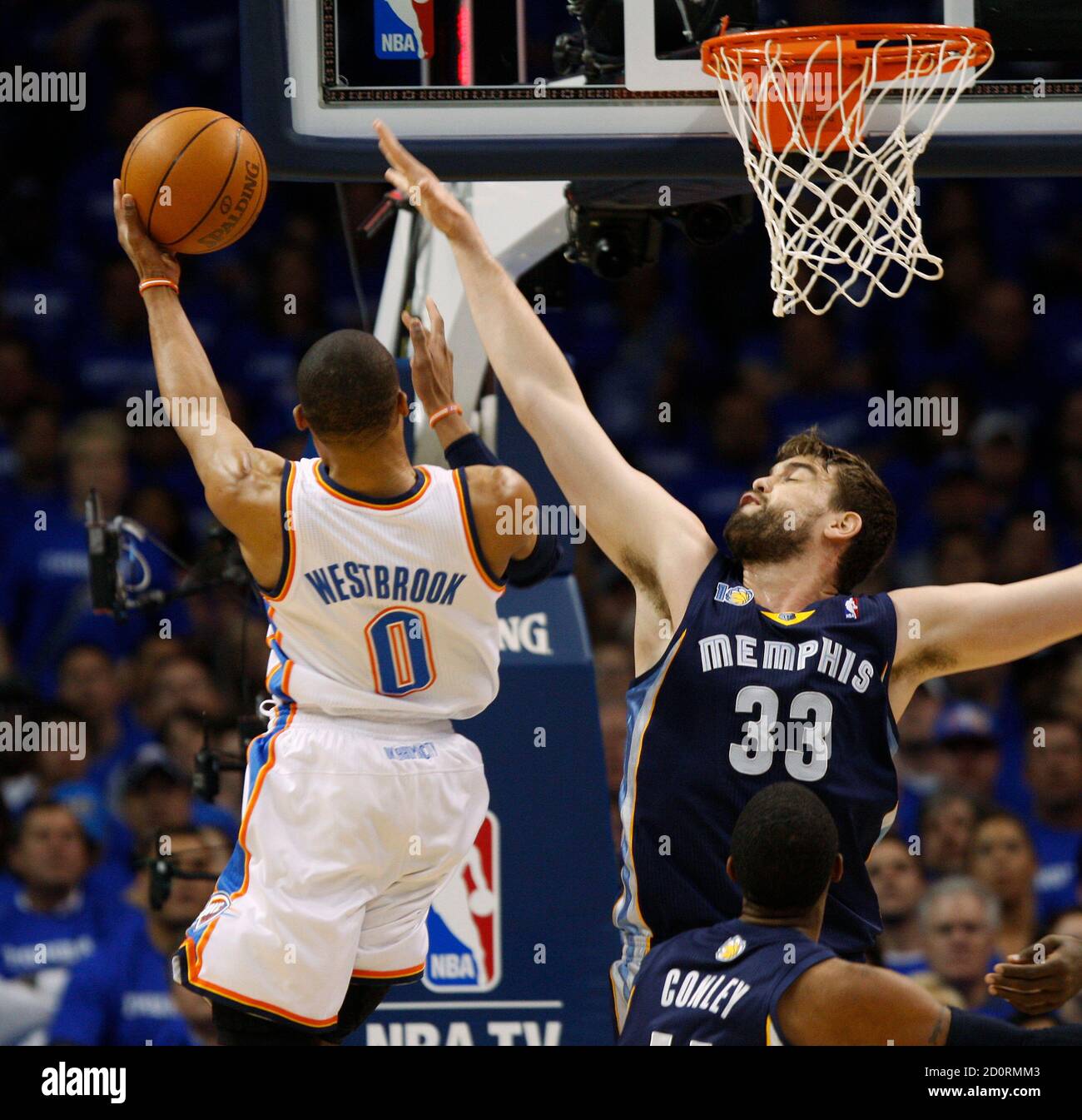 Oklahoma City Thunder guard Russell Westbrook (L) scores against Memphis  Grizzlies center Marc Gasol of Spain (R) in the first half of Game 2 of  their second round Western Conference NBA basketball