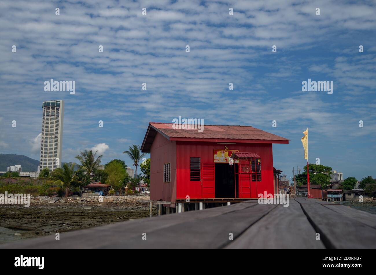 Georgetown, Penang/Malaysia - Feb 14 2020: Red old chinese temple at Tan Jetty with background KOMTAR building. Stock Photo