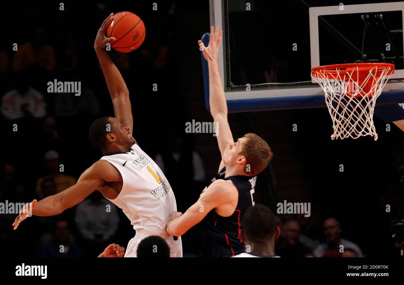 West Virginia S Dominique Rutledge L Dunks Over Uconn S Niels Giffey During Their Game At The 2012