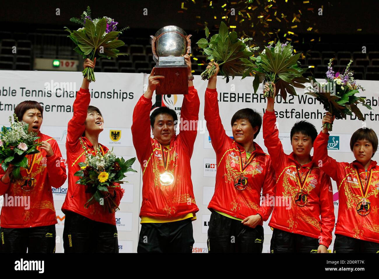 Team China celebrates with the trophy after winning the women's final  against Singapore at the Team Table Tennis Championships in Dortmund April  1, 2012. China's team members are (L-R) Li Xiaoxia, Ding