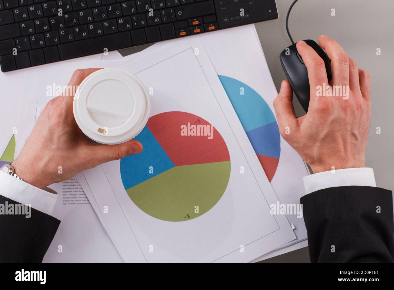 Businessman analyzing investment charts using computer at office. Stock Photo