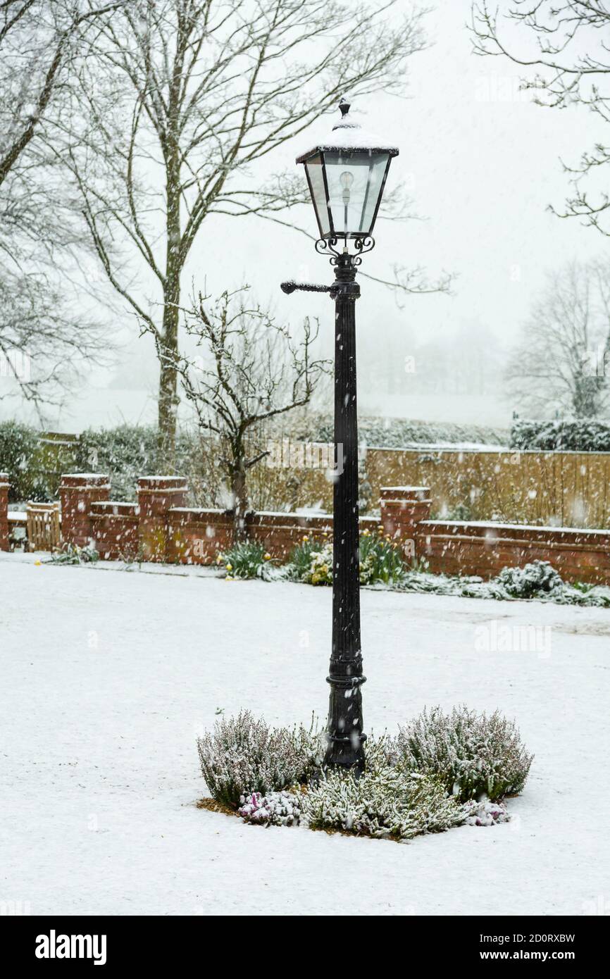 English winter garden or back yard covered in snow, UK Stock Photo