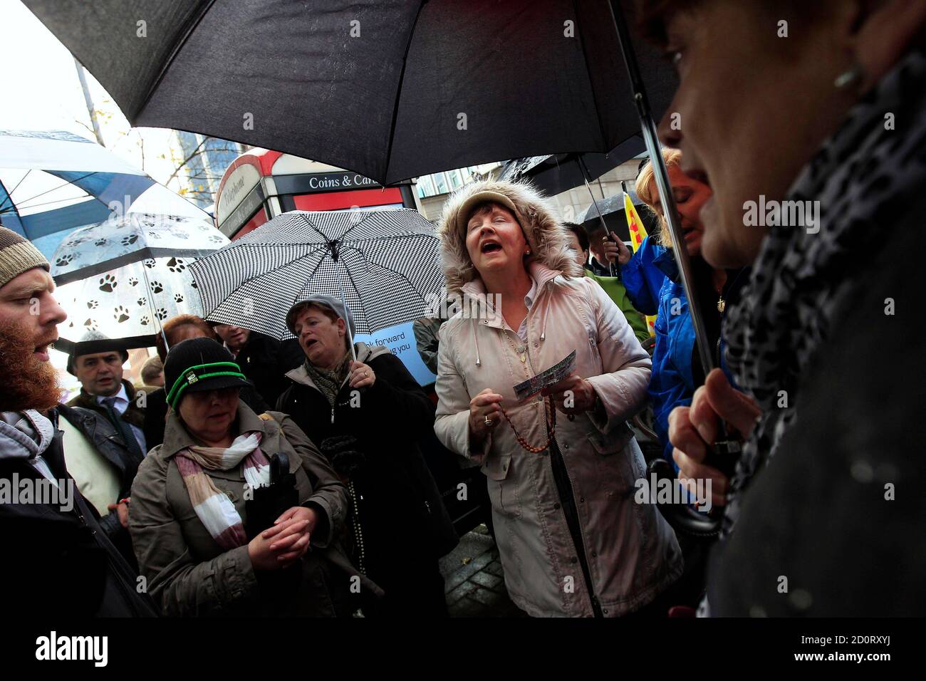 Pro-life campaigners sing hymns during a protest outside the Marie Stopes clinic in Belfast October 18, 2012. The first private clinic offering abortions opened in Northern Ireland on Thursday, making access to abortion much easier for women in both Northern Ireland and the Republic of Ireland.    REUTERS/Cathal McNaughton   (NORTHERN IRELAND - Tags: HEALTH SOCIETY RELIGION) Stock Photo