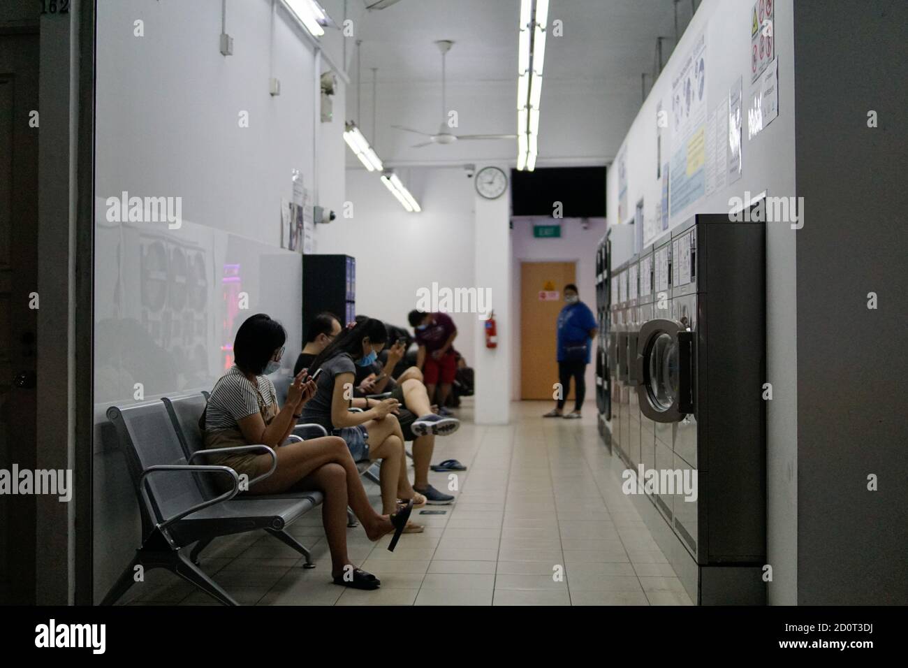 Evening scene at a launderette in Geylang, Singapore Stock Photo