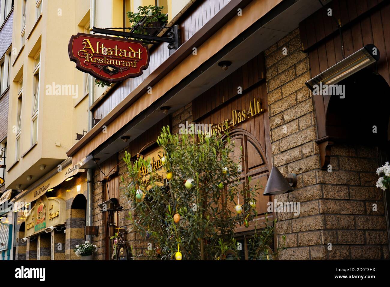 Rustic exterior of Altstadt Restaurant in the popular tourist area of Düsseldorf old town with Easter egg decoration. Stock Photo