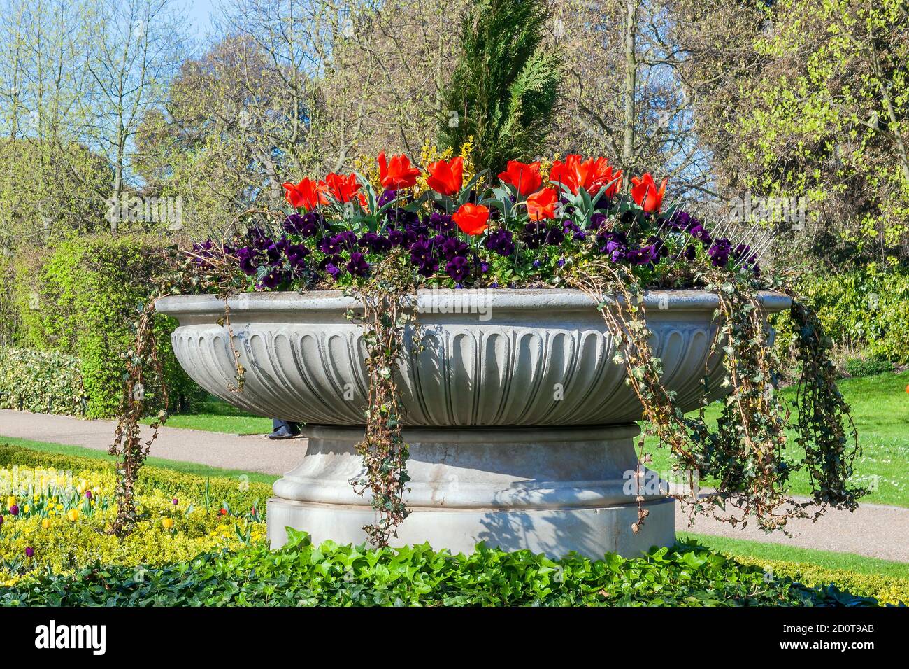Regents Park spring urn flower display in a floral flower bed which is a popular public open space in London England UK and a popular travel destinati Stock Photo